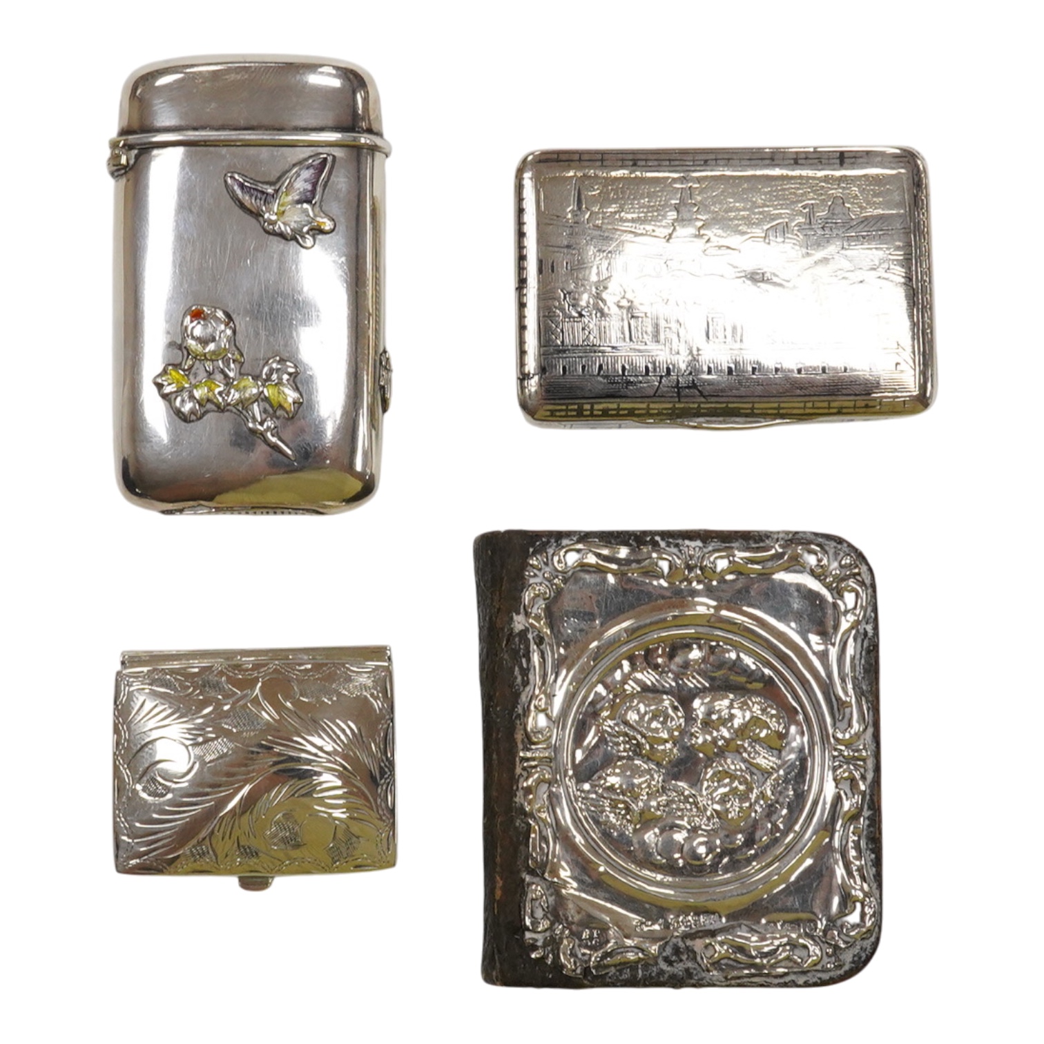 A Japanese white metal and polychrome enamel vesta case, decorated with flowers and butterfly, 56mm, together with a 19th century Russian 84 zolotnik and niello snuff box(tired), a modern silver pill box and a silver mou